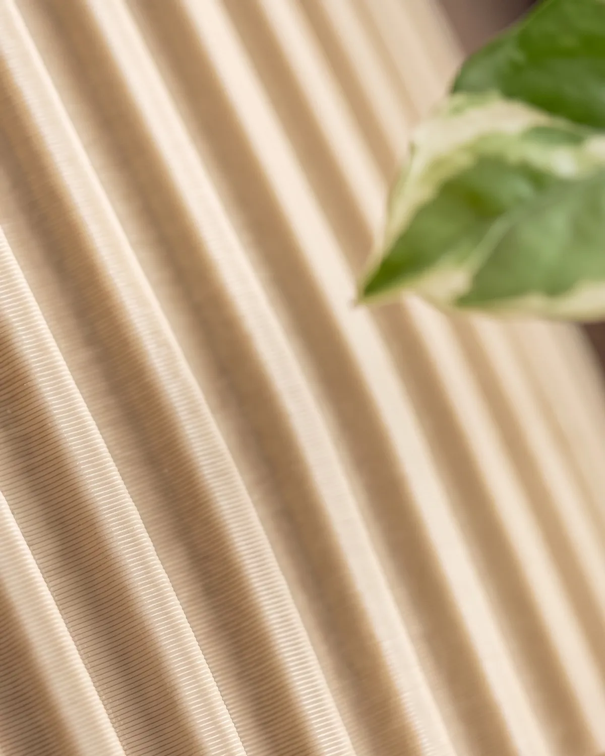 Close-up of a beige planter's ribs showing fine 3D-print layer lines